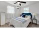 Cozy bedroom featuring a queen bed, ceiling fan, and bright natural light from the two windows at 528 Pine St, Daytona Beach, FL 32114