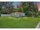 Charming single-story home with a well-manicured lawn, fenced yard, and bright orange front door at 528 Pine St, Daytona Beach, FL 32114