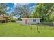 Landscaped front yard features an expansive lawn and mature trees surrounding this home at 528 Pine St, Daytona Beach, FL 32114