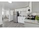 Modern kitchen featuring stainless steel appliances, white cabinets, and gray countertops at 528 Pine St, Daytona Beach, FL 32114