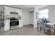 Kitchen features stainless steel appliances, white cabinets, stone countertops, and a dining area at 528 Pine St, Daytona Beach, FL 32114