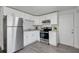 Updated kitchen with stainless steel appliances, white cabinets, and sleek gray flooring at 528 Pine St, Daytona Beach, FL 32114