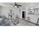Bright living room with modern furnishings, ceiling fan, and stylish decor adjacent to a view of the kitchen at 528 Pine St, Daytona Beach, FL 32114