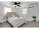 Cozy bedroom with a decorative ceiling fan, neutral color palette, and large windows at 528 Pine St, Daytona Beach, FL 32114