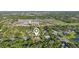 Expansive aerial view of home showcasing lush surroundings, mature trees, and nearby community amenities at 5759 Dogwood Rd, Port Orange, FL 32127