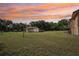 This spacious backyard features a large grassy area, mature trees, and plenty of space to enjoy the outdoors at 5759 Dogwood Rd, Port Orange, FL 32127