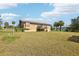 Spacious backyard offering ample space, with the house and detached suite in the background at 5759 Dogwood Rd, Port Orange, FL 32127