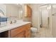 Bathroom featuring tile floors, wooden vanity, and decorative mirror over the vanity at 5759 Dogwood Rd, Port Orange, FL 32127