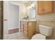 The bathroom has a wood vanity, decorative mirror and tile flooring, providing a relaxing atmosphere at 5759 Dogwood Rd, Port Orange, FL 32127