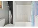 Bathroom features a white tub/shower combo with shower curtain and built in shelf at 5759 Dogwood Rd, Port Orange, FL 32127