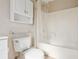 Bright bathroom featuring a white tub/shower combo and a white cabinet above the toilet at 5759 Dogwood Rd, Port Orange, FL 32127