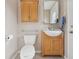 Cozy bathroom featuring a classic vanity with vessel sink, wall cabinet, and neutral color palette at 5759 Dogwood Rd, Port Orange, FL 32127