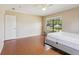 This bedroom features wood floors, neutral paint, and a large window with a picturesque outdoor view at 5759 Dogwood Rd, Port Orange, FL 32127