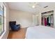 Bedroom featuring wood floors, closet, and a navy blue accent chair at 5759 Dogwood Rd, Port Orange, FL 32127