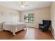 Bedroom featuring wood floors and a large window at 5759 Dogwood Rd, Port Orange, FL 32127