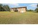Exterior view showcasing the home with a walk-out basement and a wooden deck at 5759 Dogwood Rd, Port Orange, FL 32127