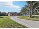 Charming stone facade home with a well-manicured lawn and mature trees creating curb appeal at 5759 Dogwood Rd, Port Orange, FL 32127