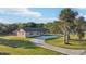 Lovely exterior showcasing the home's facade, beautiful front yard, and circular driveway at 5759 Dogwood Rd, Port Orange, FL 32127