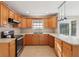 Kitchen featuring wooden cabinets, stainless steel appliances, and plenty of counter space at 5759 Dogwood Rd, Port Orange, FL 32127
