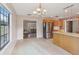 Kitchen with stainless steel appliances, wood cabinets, tile floors, and an open view to the living room at 5759 Dogwood Rd, Port Orange, FL 32127