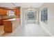 Bright kitchen and breakfast nook featuring wooden cabinetry, large windows, and tile flooring at 5759 Dogwood Rd, Port Orange, FL 32127