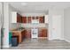 This kitchen features wood cabinets, white appliances, and tile floors at 5759 Dogwood Rd, Port Orange, FL 32127