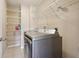 Laundry room features tile flooring, wire rack shelving, and front loading washer and dryer at 5759 Dogwood Rd, Port Orange, FL 32127