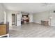 Open floor plan includes living area, kitchen with appliances, laundry closet, and wood-look tile flooring at 5759 Dogwood Rd, Port Orange, FL 32127