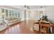 Spacious living room with hardwood floors, a ceiling fan and a large bay window at 5759 Dogwood Rd, Port Orange, FL 32127