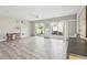 Open-concept living area with white tile flooring, a ceiling fan, and sliding glass doors with sheer curtains at 5759 Dogwood Rd, Port Orange, FL 32127