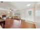 Spacious living room with hardwood floors, fireplace, ceiling fan and a large bay window at 5759 Dogwood Rd, Port Orange, FL 32127