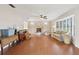 Spacious living room with hardwood floors, fireplace, ceiling fan and a large bay window at 5759 Dogwood Rd, Port Orange, FL 32127
