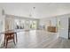 Open-concept living area with white tile flooring, a ceiling fan, and sliding glass doors to the backyard at 5759 Dogwood Rd, Port Orange, FL 32127