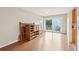 Spacious living room with wood floors and a sliding glass door to the outside patio at 5759 Dogwood Rd, Port Orange, FL 32127