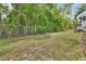 A spacious backyard is enclosed by a chain-link fence and features lush greenery at 600 N Boundary Ave # 420, Deland, FL 32720