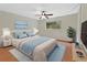 Bright bedroom featuring hardwood floors, ceiling fan, and a window view with modern furniture at 600 N Boundary Ave # 420, Deland, FL 32720