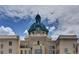 Historic building featuring a clock tower and classic architectural details against a partly cloudy, blue sky at 600 N Boundary Ave # 420, Deland, FL 32720