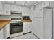 Bright kitchen with white cabinets, tile floor, and modern appliances at 600 N Boundary Ave # 420, Deland, FL 32720