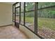 Enclosed lanai features neutral tile floor and a backyard view at 600 N Boundary Ave # 420, Deland, FL 32720