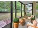 Enclosed lanai features neutral tile floor, green plants, outdoor seating, and a backyard view at 600 N Boundary Ave # 420, Deland, FL 32720