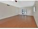 Spacious living room with wood floors, ceiling fan and French doors at 600 N Boundary Ave # 420, Deland, FL 32720