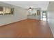 Bright open concept living space with wood floors and kitchen view at 600 N Boundary Ave # 420, Deland, FL 32720