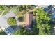 Aerial view showcasing the home's layout, surrounding greenery, driveway, and proximity to the neighborhood streets at 611 N Garfield Ave, Deland, FL 32724