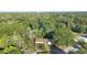 Aerial shot of the home set amidst lush green trees, highlighting its serene location and neighborhood setting at 611 N Garfield Ave, Deland, FL 32724