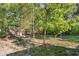 Backyard with a privacy fence, grassy area, and mature trees creating a serene and natural outdoor space at 611 N Garfield Ave, Deland, FL 32724