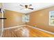 This bedroom features neutral walls, bright windows, hardwood floors, and a modern ceiling fan at 611 N Garfield Ave, Deland, FL 32724
