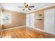 This bedroom features neutral walls, bright windows, hardwood floors, and three closets for ample storage at 611 N Garfield Ave, Deland, FL 32724