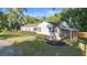 Charming single-story home with well-maintained landscaping, a covered carport, and a welcoming front entrance at 611 N Garfield Ave, Deland, FL 32724
