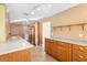The kitchen has light countertops, wood cabinets, and tile floors at 611 N Garfield Ave, Deland, FL 32724