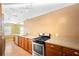 Kitchen with gas range, tile floor and wood cabinets at 611 N Garfield Ave, Deland, FL 32724